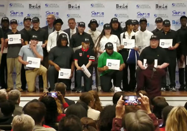 NNPS students receiving job offers posing on stage with certificates